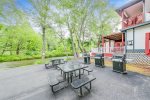 Backyard grills & picnic tables by the river at the condo
